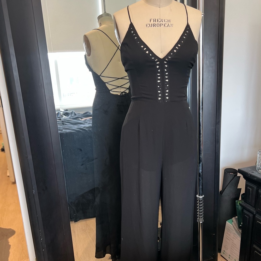 Black criss cross cut out jumpsuit with tie back size M